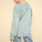 VERY J Here There And Everywhere Washed V-Neck Exposed Seam Knit Top in Sage